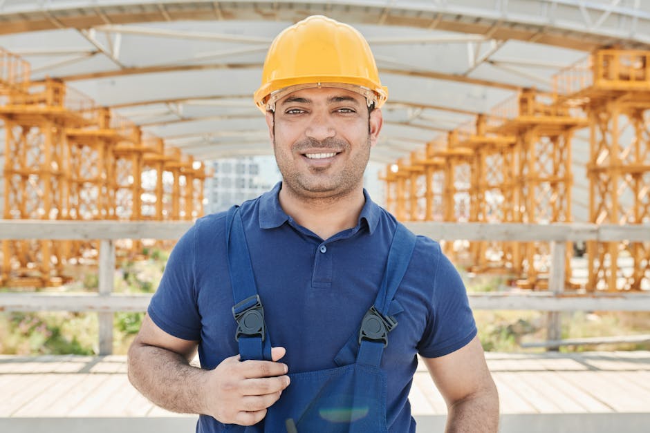 Friendly and professional construction worker wearing a hard hat and smiling